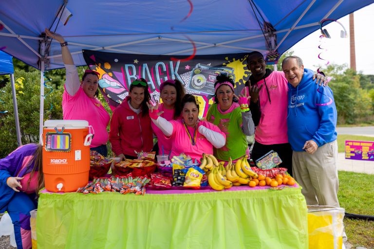 Fundraisers under a tent at a bike to the beach event