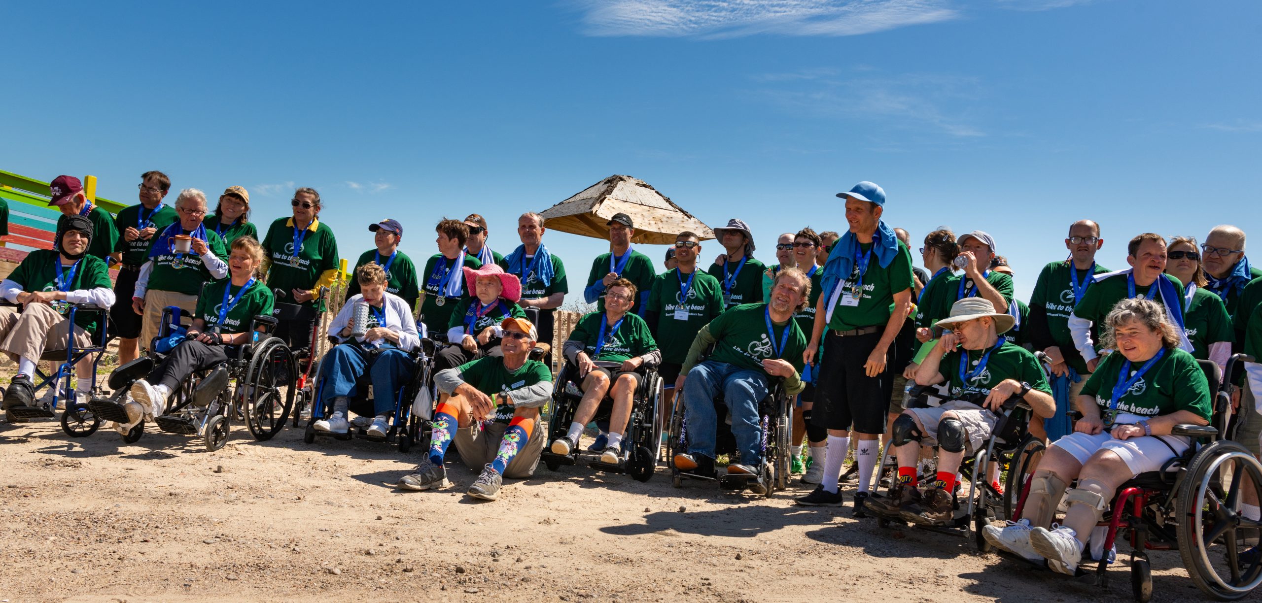 A group of bike to the beach riders of ALL abilities posing after completing the ride