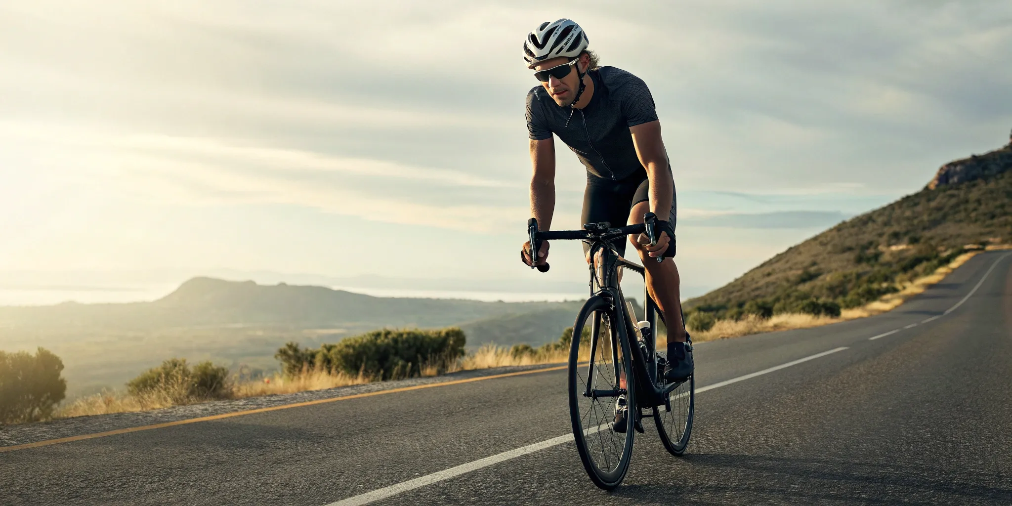 A cyclist training on a hilly road for a 50 mile bike ride.